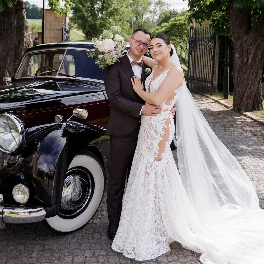 Para młoda przy klasycznym samochodzie przed Pałacem Brunów – fotografia ślubna Wrocław